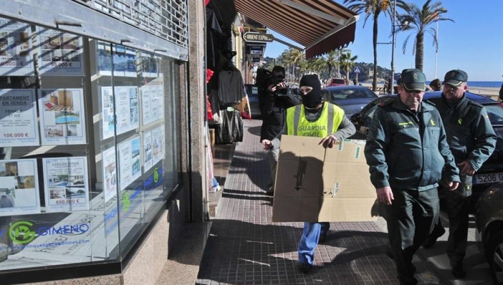 Miembros de la Guardia civil se disponen a entrar en la inmobiliaria sospechosa