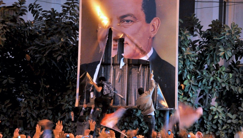 Manifestantes queman una foto de Mubarak 