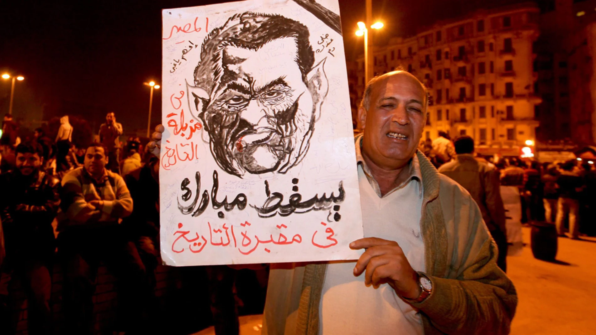 Un hombre muestra un retrato de Hosni Mubarak Un hombre muestra un retrato de Hosni Mubarak