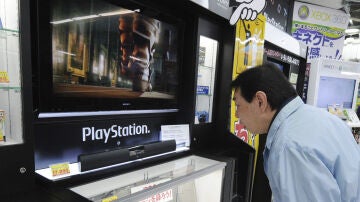 Un hombre observa una consola de PlayStation