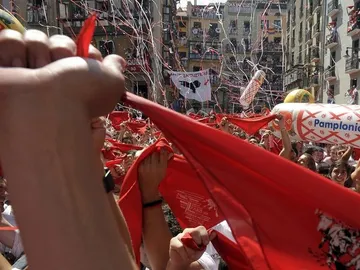 Jóvenes entusiastas alzan sus pañuelos tras el "Chupinazo" Jóvenes entusiastas alzan sus pañuelos tras el "Chupinazo"