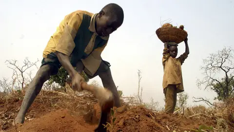Imagen de archivo de dos niños trabajando en el campo en Nigeria. Imagen de archivo de dos niños trabajando en el campo en Nigeria.