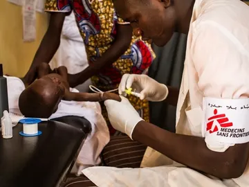 Un enfermero de MSF cuida a un niño aquejado de desnutrición Un enfermero de MSF cuida a un niño aquejado de desnutrición