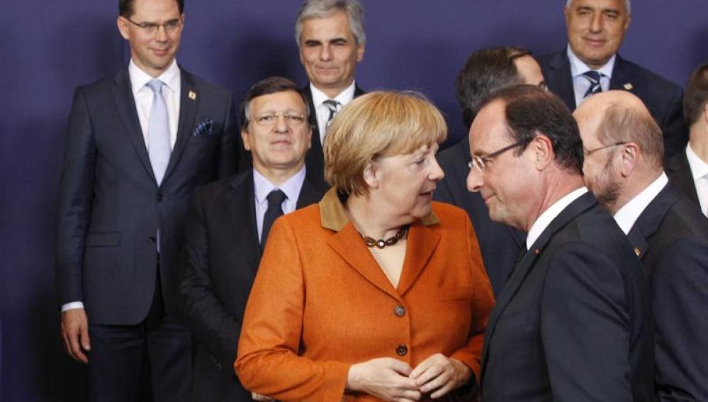 La canciller alemana Angela Merkel (i) conversa con el presidente francés François Hollande 