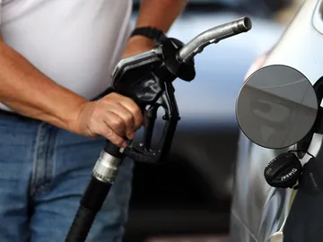 Un consumidor repostando gasolina Un consumidor repostando gasolina