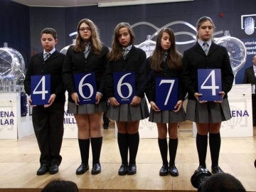 Los niños de San Ildefonso posan con el número de la Lotería.