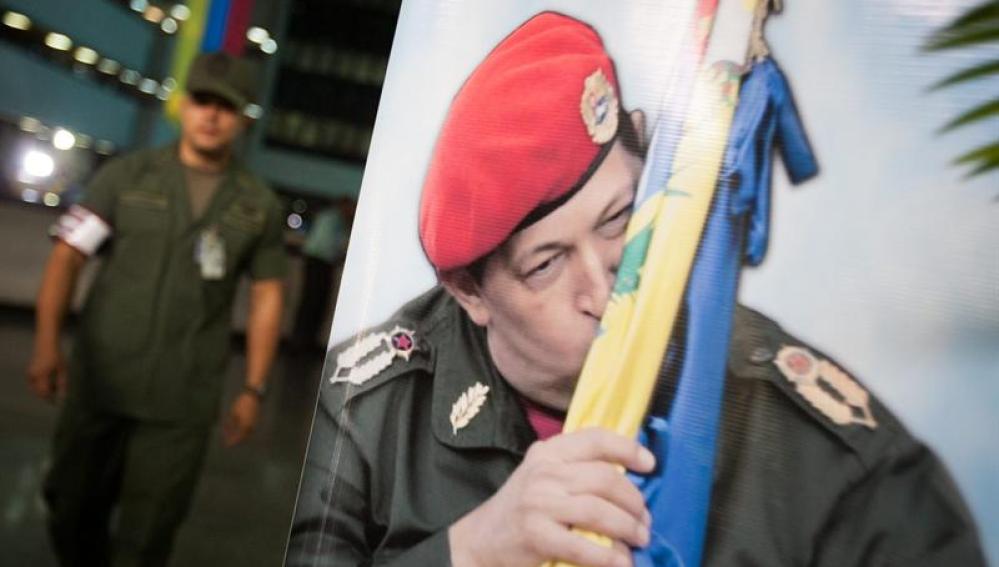 Un soldado camina cerca de un afiche del presidente de Venezuela