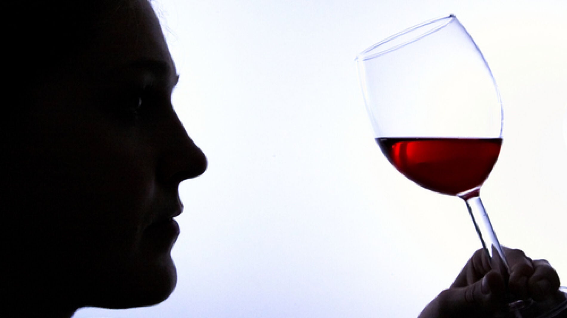 Un hombre bebe vino tinto