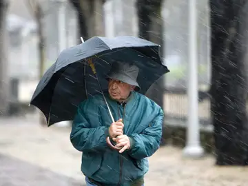 Un hombre se refugia de la lluvia en Vitoria Un hombre se refugia de la lluvia en Vitoria