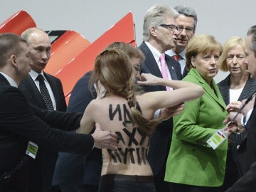 El presidente ruso, Vladimír Putin, y la canciller alemana, Angela Merke, se ven sorprendidos por una activista de Femen