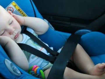 Un bebé duerme en el interior de un vehículo Un bebé duerme en el interior de un vehículo