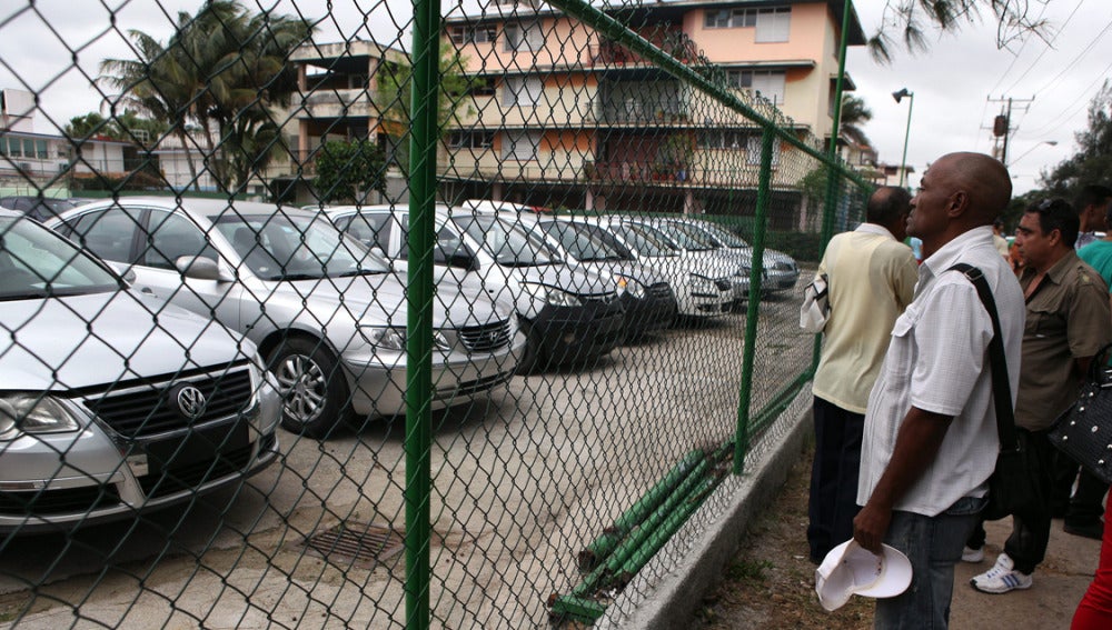 Varios cubanos observan los coches