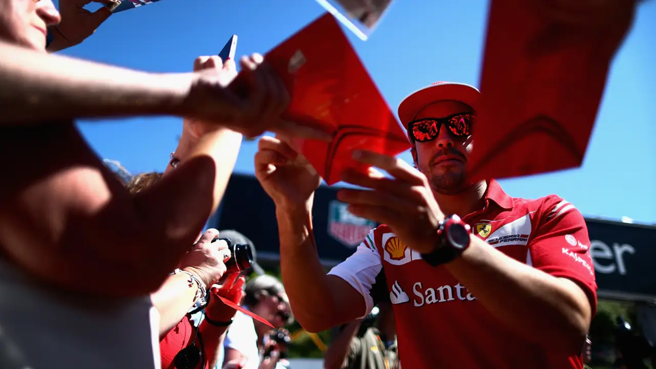 Alonso firma unos autógrafos