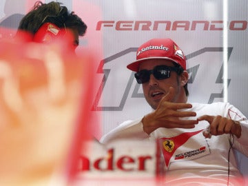Alonso conversa en el box de Ferrari