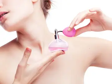 Una chica perfumándose Una chica perfumándose