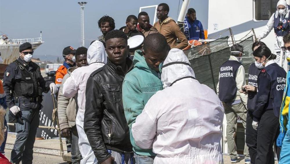 Un grupo de inmigrantes rescatado por un barco RBD desembarca al puerto de Corigliano Calabro (Italia) 