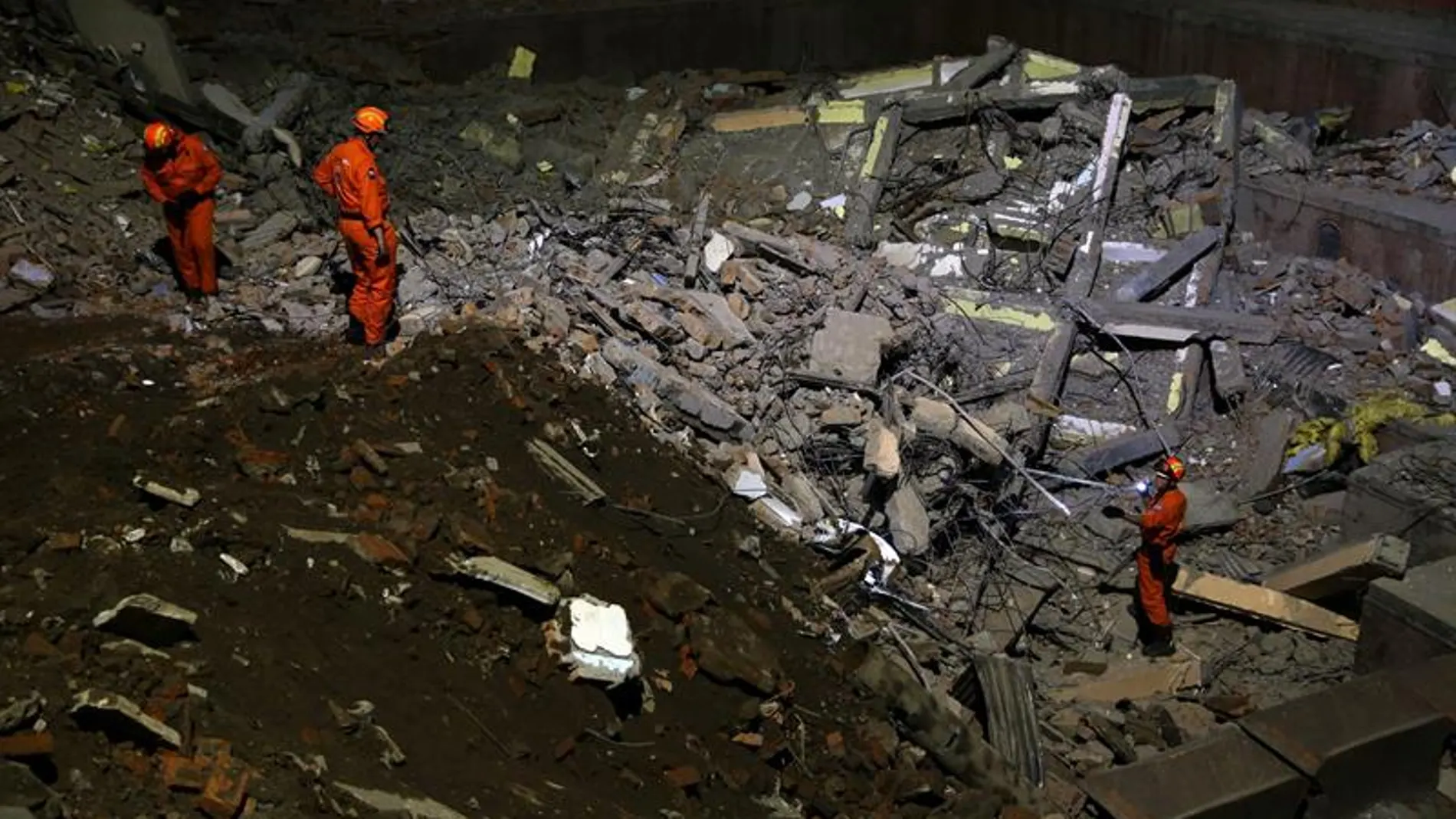 Varios miembros de un equipo de rescate buscan supervivientes Varios miembros de un equipo de rescate buscan supervivientes