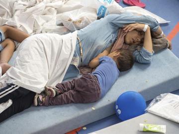 Varias personas descansan en un centro para refugiados de Deggendorf, Alemania Varias personas descansan en un centro para refugiados de Deggendorf, Alemania