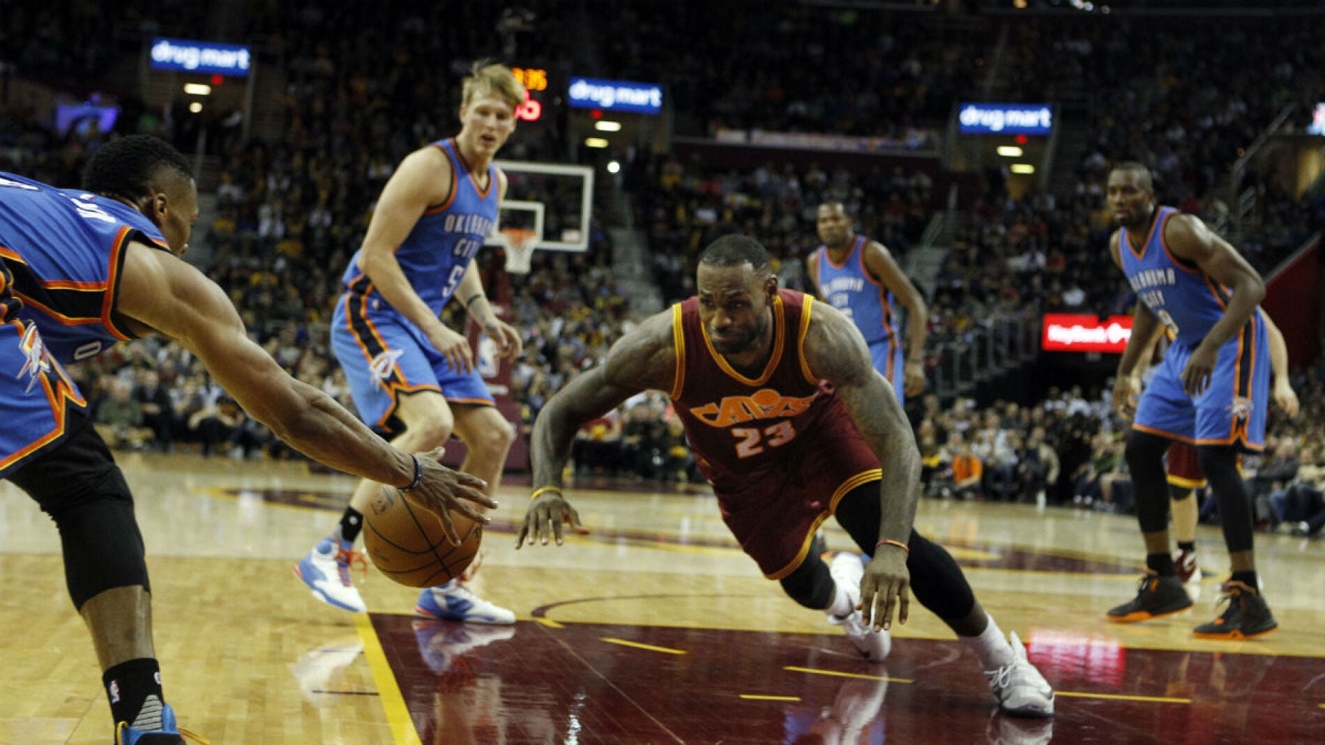 LeBron James trata de cazar un bal&oacute;n ante los jugadores de Oklahoma