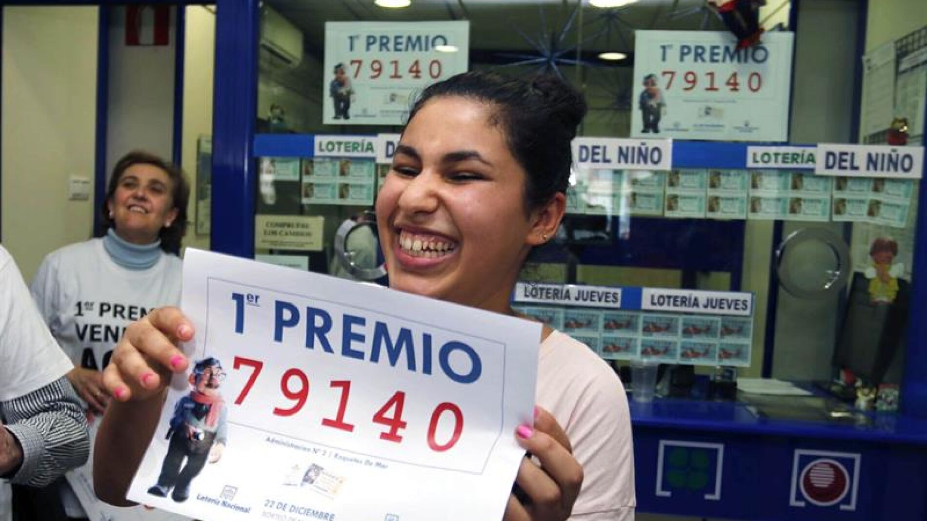 Una joven sonr&iacute;e con una copia del n&uacute;mero 79.140