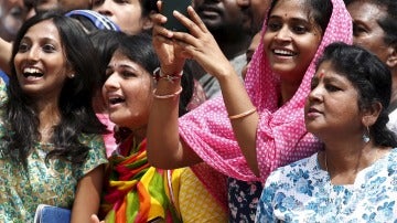 Una mujer india intenta hacer una foto con su móvil