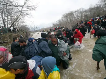 Los refugiados han cruzado un río para atravesar la frontera Los refugiados han cruzado un río para atravesar la frontera