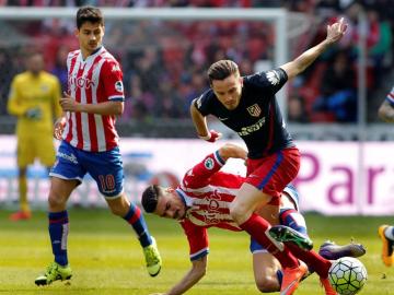 Saúl pelea el balón ante los defensores del Sporting de Gijón