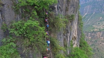 Niños chinos escalan roca para ir al colegio