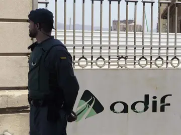 Un agente custodia el acceso a la sede en Barcelona del gestor de infraestructuras Adif en la Sagrera. Un agente custodia el acceso a la sede en Barcelona del gestor de infraestructuras Adif en la Sagrera.