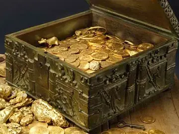 Un cofre lleno de monedas - Imagen de archivo Un cofre lleno de monedas - Imagen de archivo