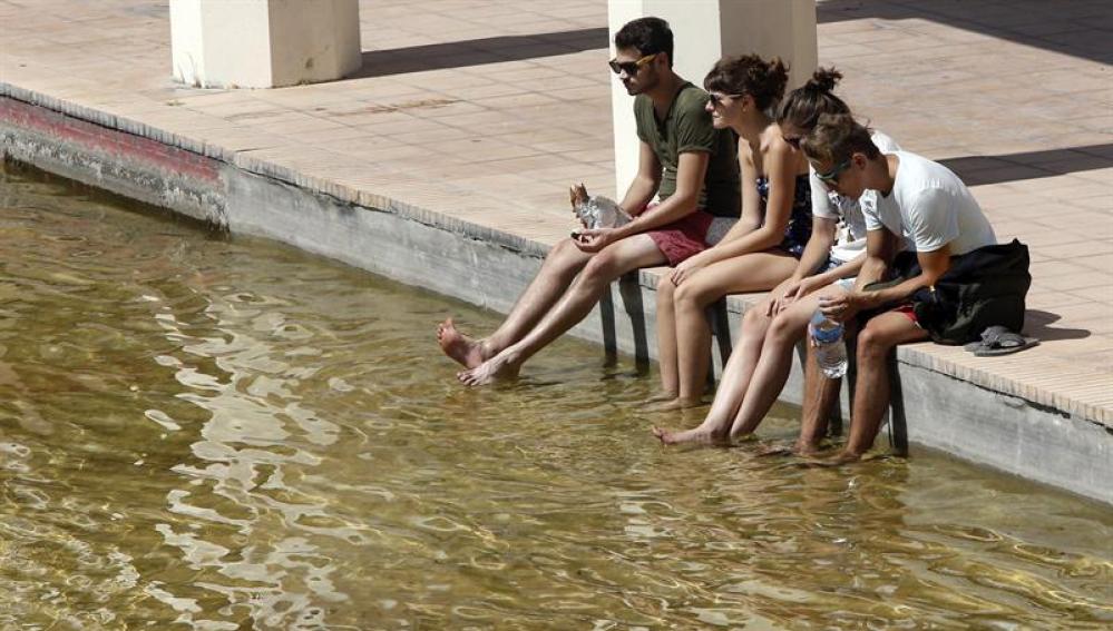 Un grupo de jóvenes se refresca los pies