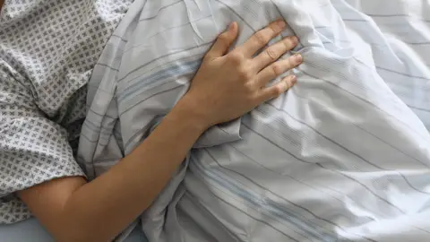 Un enfermo en una cama de un hospital Un enfermo en una cama de un hospital