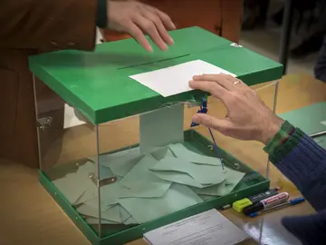 Un ciudadano ejerce su derecho a voto introduciendo la papeleta en la urna Un ciudadano ejerce su derecho a voto introduciendo la papeleta en la urna
