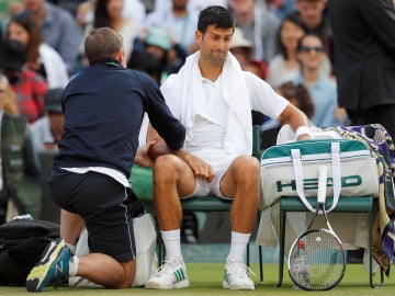 Novak Djokovic, atendido por un fisioterapeuta en Wimbledon