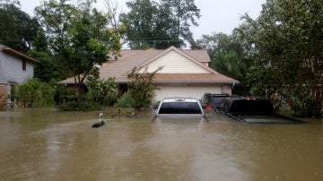 Casas y coches parcialmente sumergidos por las aguas a causa de la tormenta tropical Harvey en el este de Houston, Texas