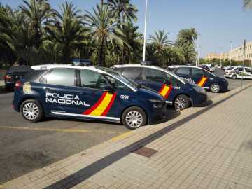 Coches de la Policía Nacional estacionados junto a la Comisaría de Elche.