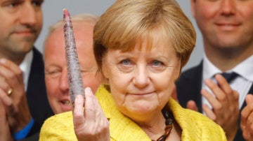 La canciller alemana, Angela Merkel, candidata del Partido de la Unión Demócrata Cristiana (CDU) para las próximas elecciones generales, tiene una hortaliza durante una manifestación en Friburgo, Alemania