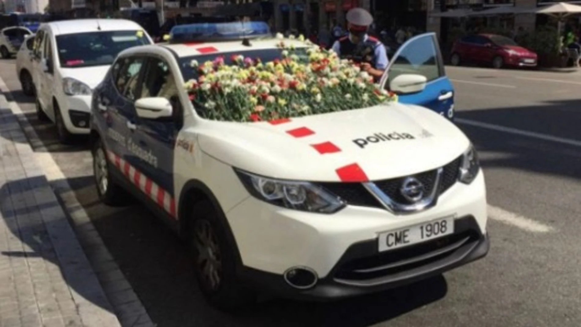 Coche de los Mossos, con claveles Coche de los Mossos, con claveles