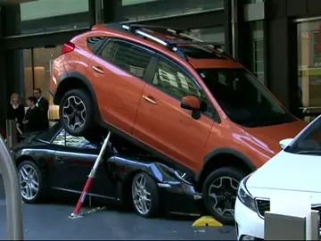 Un aparcacoches de un hotel introduce un deportivo debajo de un todoterreno Un aparcacoches de un hotel introduce un deportivo debajo de un todoterreno