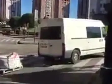 Una furgoneta conduce con un palé de madera enganchado a la parte trasera Una furgoneta conduce con un palé de madera enganchado a la parte trasera