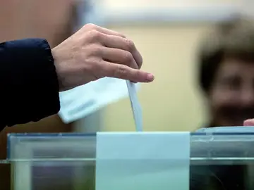 Un ciudadano deposita su voto en una urna Un ciudadano deposita su voto en una urna