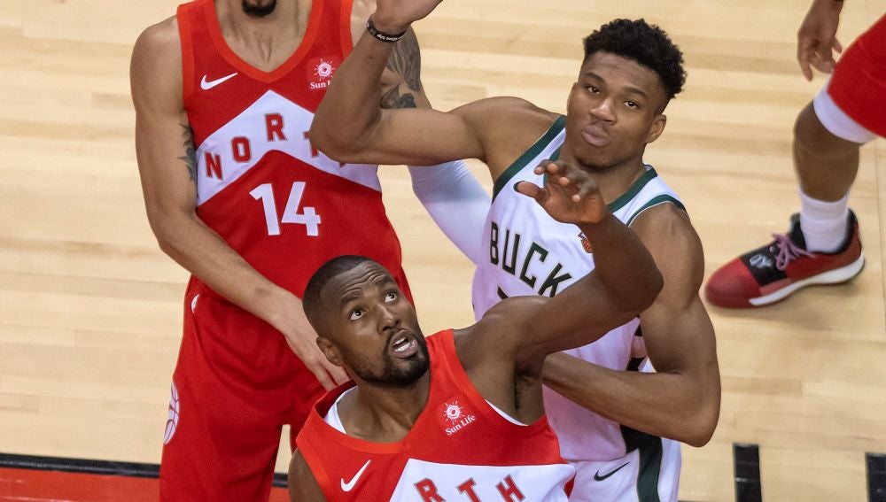 Giannis Antetokounmpo y Serge Ibaka pelean por un balón