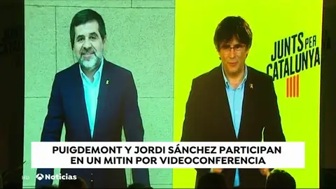 Carles Puigdemont y Jordi Sànchez hacen un mitin a través de una pantalla y piden el voto para "ayudar" a los presos Carles Puigdemont y Jordi Sànchez hacen un mitin a través de una pantalla y piden el voto para "ayudar" a los presos