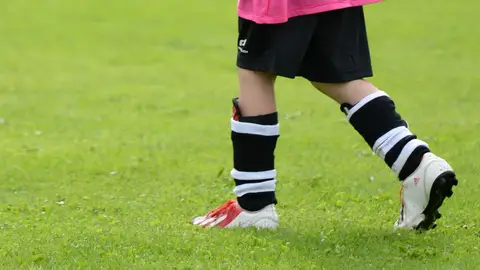 Imagen de archivo | Niño o niña jugando al fútbol Imagen de archivo | Niño o niña jugando al fútbol