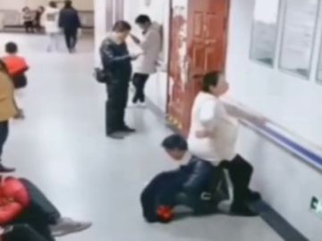 Un hombre hace de 'silla' a su mujer embarazada al ver que nadie le cede su asiento en un hospital de China