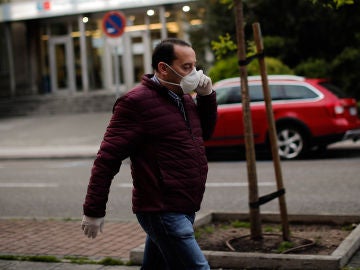 Un hombre con mascarilla pasea por las calles de Madrid