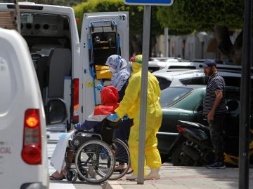 Varios trabajadores sanitarios trasladan a un enfermo en Melilla