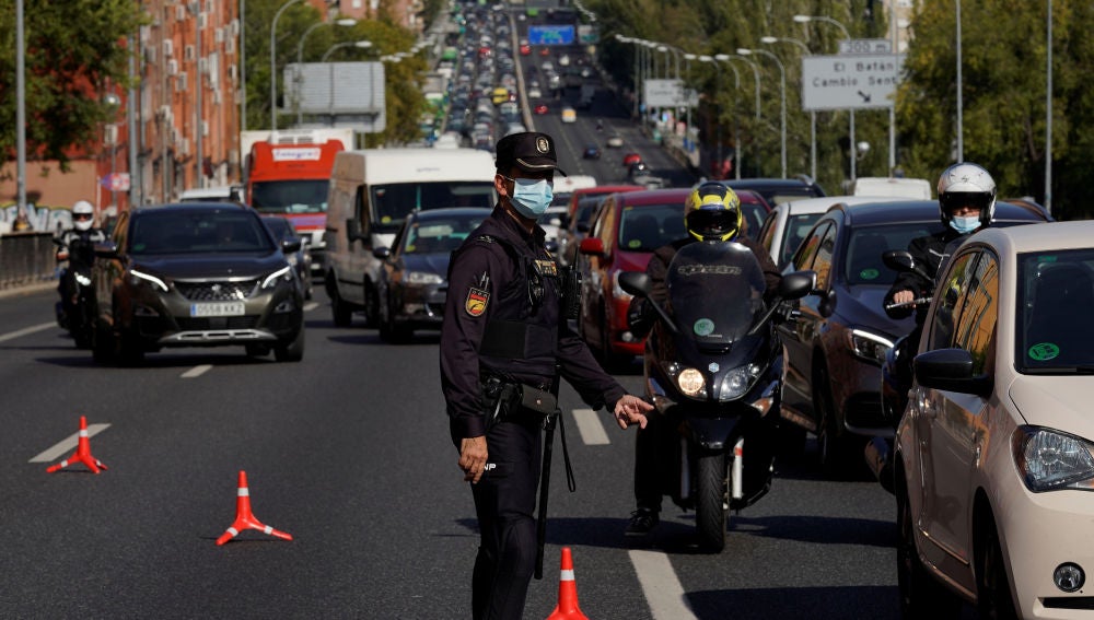 Un agente controla la movilidad en la salida de Madrid (Archivo)