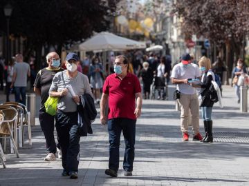 Personas con mascarilla pasean en Alcalá de Henares