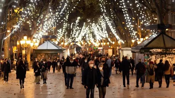 Gente paseando por el paseo Born en Barcelona con el encendido navide&ntilde;o